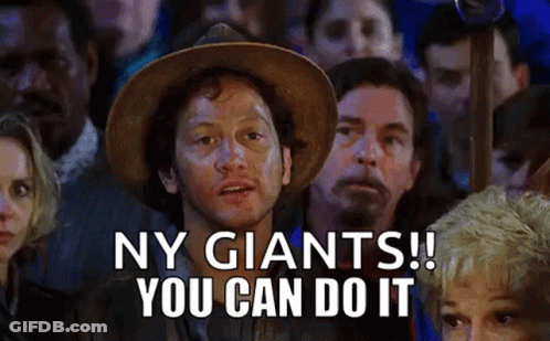 A Man In A Cowboy Hat Is Standing In Front Of A Crowd Of People And Saying Ny Giants ! You Can Do It . GIF