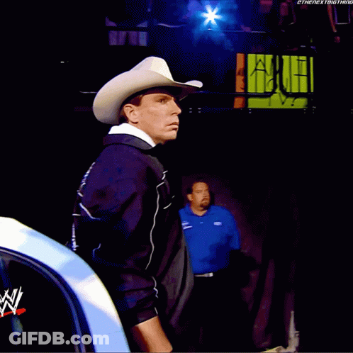 A Man In A Cowboy Hat Is Standing In Front Of A Summer Slam Sign GIF
