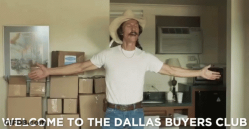 A Man In A Cowboy Hat Is Standing In Front Of Boxes And The Words Welcome To The Dallas Buyers Club GIF