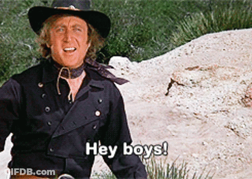 A Man In A Cowboy Hat Is Standing In The Dirt And Saying Hey Boys GIF