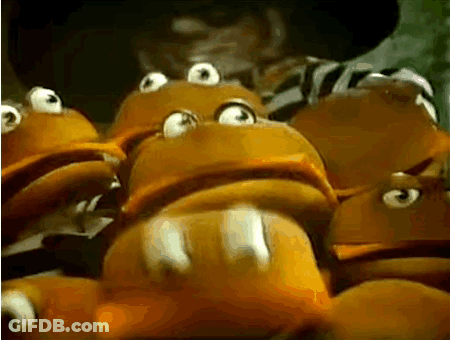 A Man In A Cowboy Hat Is Standing Next To A Bunch Of Frogs With Big Eyes . GIF