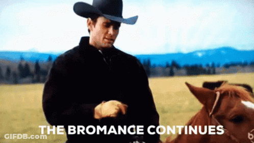 A Man In A Cowboy Hat Is Standing Next To A Horse In A Field With The Words " The Bromance Continues " Above Him GIF