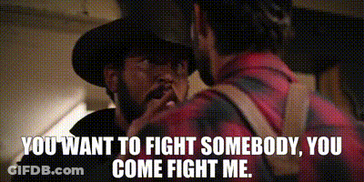 A Man In A Cowboy Hat Is Talking To Another Man In A Plaid Shirt .. GIF