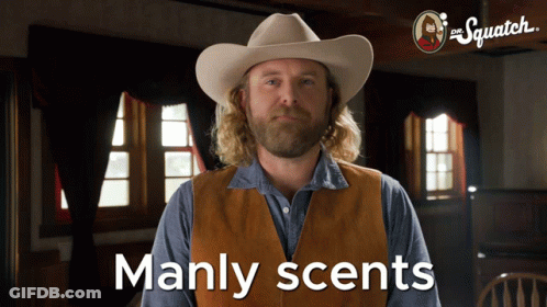 A Man In A Cowboy Hat Says Manly Scents In Front Of A Sign That Says The Squatch GIF