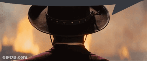 A Man In A Cowboy Hat Stands In Front Of A Large Fire GIF