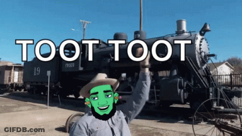 A Man In A Cowboy Hat Stands In Front Of A Train With The Words Toot Toot On It GIF