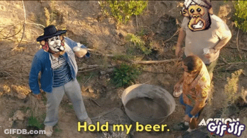 A Man In A Cowboy Hat Stands In The Dirt With The Words Hold My Beer GIF