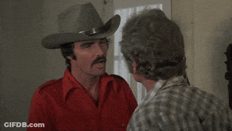 A Man In A Cowboy Hat Talks To Another Man With The Words " For The Good Old American " Above Him GIF