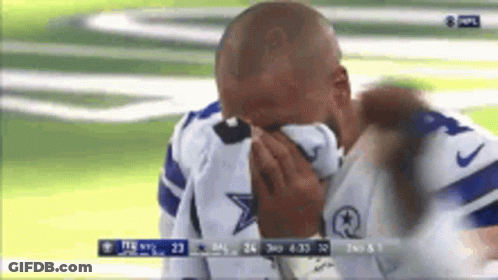 A Man In A Cowboys Jersey Is Crying On A Field GIF