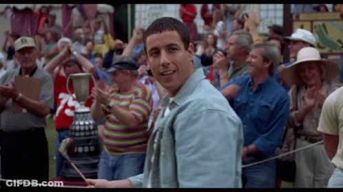 A Man In A Crowd Holds A Trophy With The Number 1000 On It GIF