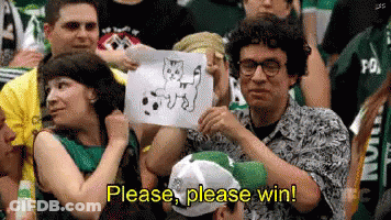 A Man In A Crowd Holds Up A Drawing Of A Cat And Says Please Please Win GIF
