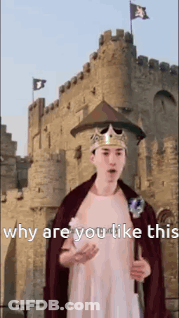 A Man In A Crown And Cape Is Standing In Front Of A Castle Holding A Sword . GIF