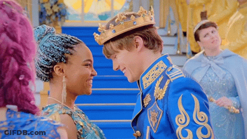 A Man In A Crown Is Standing Next To A Woman In A Blue Dress And Looking At Her . GIF