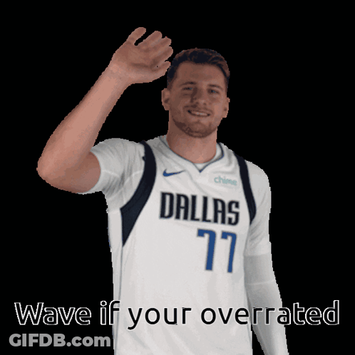 A Man In A Dallas 77 Jersey Is Waving His Hand GIF