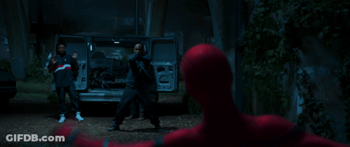 A Man In A Dark Room Is Holding A Gun GIF