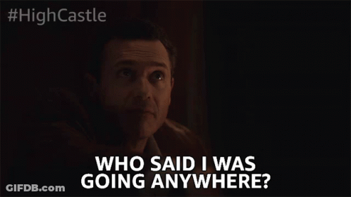 A Man In A Dark Room Says " Who Said I Was Going Anywhere " GIF