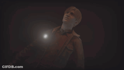 A Man In A Dark Room With A Flashlight GIF