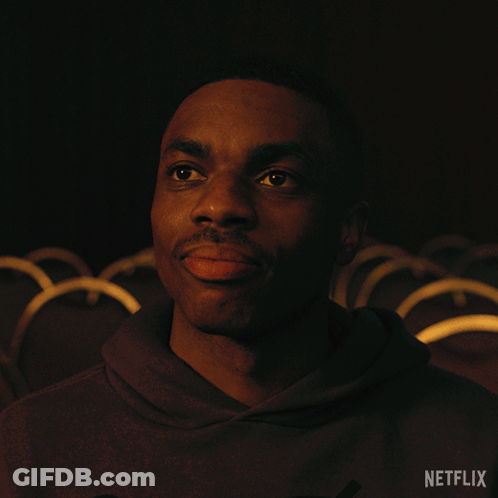 A Man In A Dark Room With A Netflix Logo In The Corner GIF