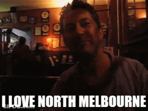A Man In A Dark Room With The Words I Love North Melbourne Below Him GIF