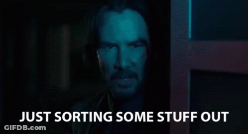 A Man In A Dark Room With The Words `` Just Sorting Some Stuff Out '' Written On The Bottom . GIF