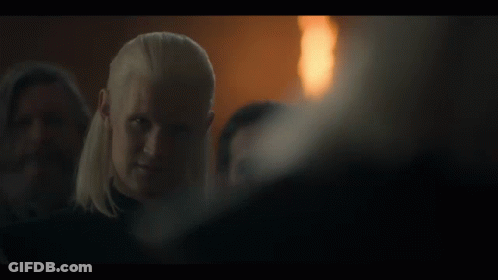 A Man In A Dark Room With The Words Say It Below Him GIF