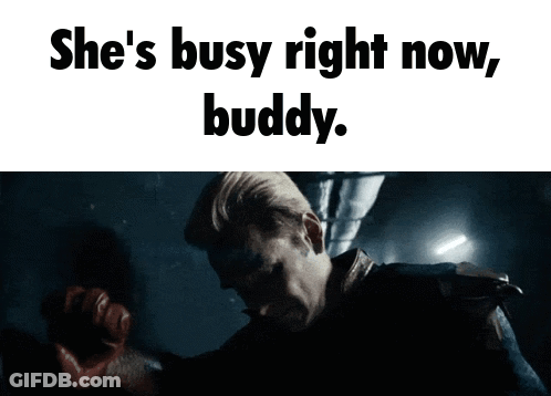 A Man In A Dark Room With The Words She 'S Busy Right Now Buddy Above Him GIF