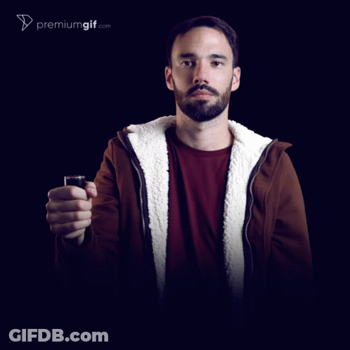A Man In A Darth Vader Mask Holding A Red Light Saber GIF
