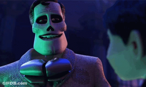 A Man In A Day Of The Dead Costume Is Smiling GIF