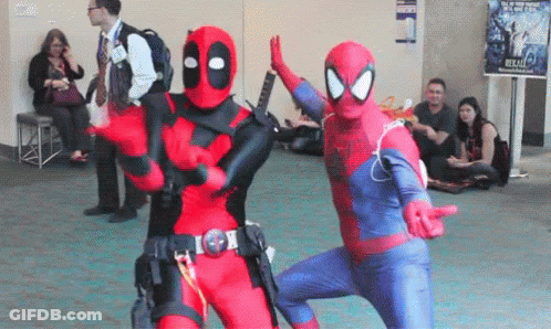 A Man In A Deadpool Costume And A Man In A Spiderman Costume Are Dancing Together . GIF