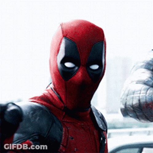 A Man In A Deadpool Costume Holds A Gun GIF