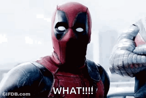 A Man In A Deadpool Costume Is Giving A Thumbs Up And Saying `` What ! '' GIF