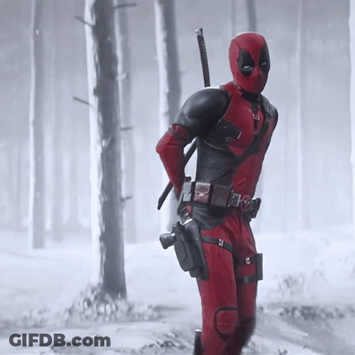 A Man In A Deadpool Costume Is Holding A Sword GIF