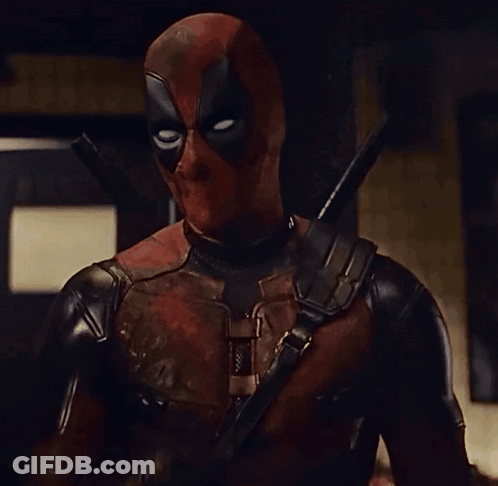 A Man In A Deadpool Costume Is Holding A Sword GIF