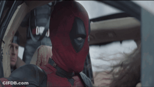 A Man In A Deadpool Costume Is In A Car GIF