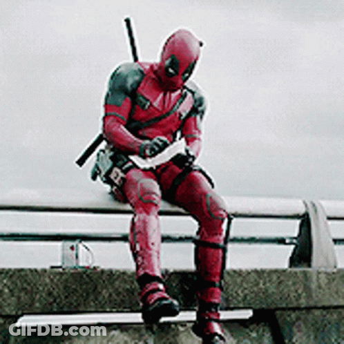 A Man In A Deadpool Costume Is Sitting On A Ledge . GIF