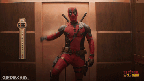 A Man In A Deadpool Costume Is Standing In A Elevator GIF