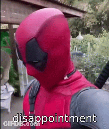 A Man In A Deadpool Costume Is Standing In Front Of A Fence With Disappointment Written On His Face . GIF