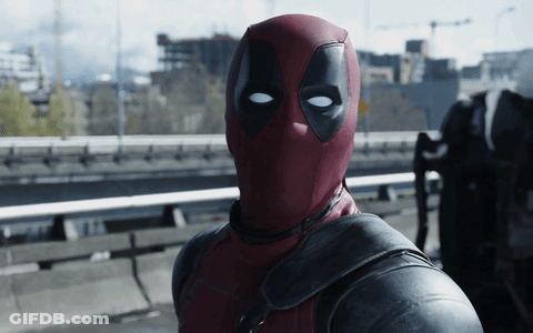 A Man In A Deadpool Costume Is Standing On A Highway GIF