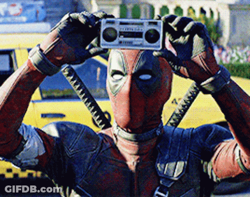 A Man In A Deadpool Costume Is Taking A Picture Of Himself With A Boombox GIF