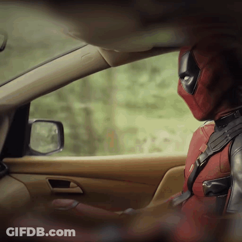 A Man In A Deadpool Costume Sits In A Car GIF