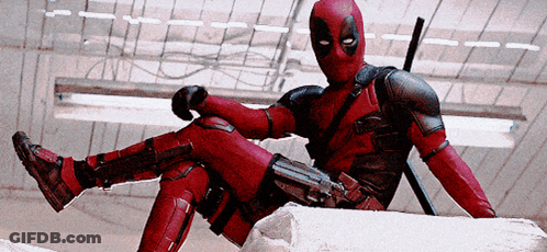 A Man In A Deadpool Costume Sits On A Rock GIF