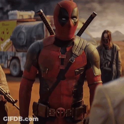 A Man In A Deadpool Costume Stands In A Desert GIF