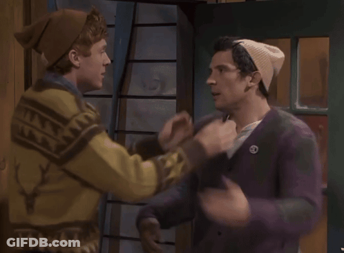 A Man In A Deer Sweater Kisses Another Man GIF