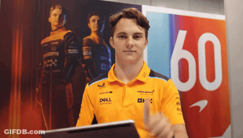 A Man In A Dell Shirt Giving A Thumbs Up In Front Of A Sign With The Number 60 GIF
