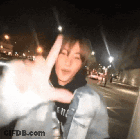 Man In Denim Jacket Making Peace Sign GIF