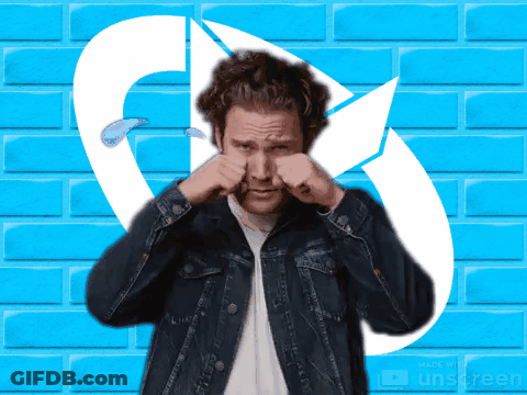 A Man In A Denim Jacket Is Rubbing His Nose In Front Of A Blue Brick Wall Made By Unscreen GIF