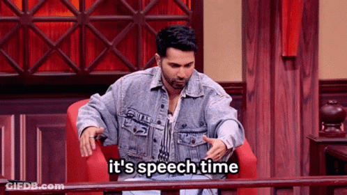 A Man In A Denim Jacket Is Sitting In A Chair With The Words It 'S Speech Time Below Him GIF
