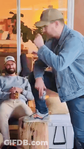 A Man In A Denim Jacket Is Standing Next To A Man In A Baseball Cap GIF