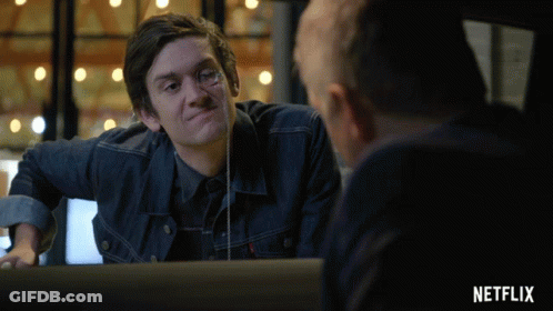 Man In Denim Jacket Looking In Mirror With Netflix Logo GIF