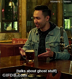 A Man In A Denim Jacket Sits At A Bar With A Mug Of Beer And Talks About Ghost Stuff GIF